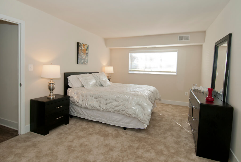 Master bedroom with black furniture and white bedding